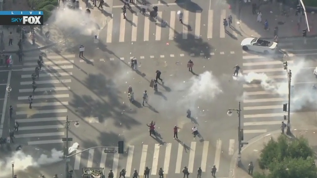 Crowds throw tear gas canister back at police