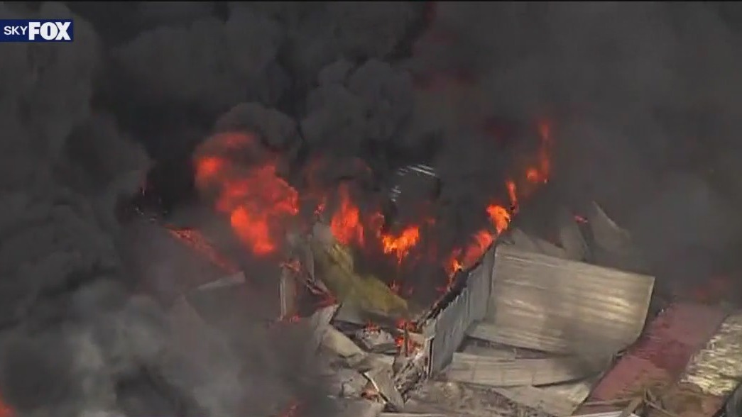 Brush fire burns storage facility