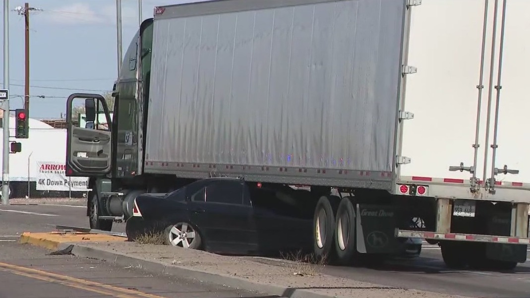Car crashes into semi, gets wedged underneath