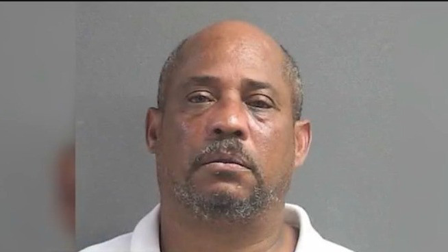 Man accused of pointing gun at kids at bus stop