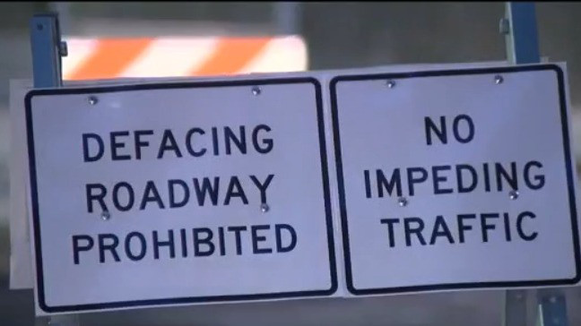 New signs posted near crosswalk by Pulse site