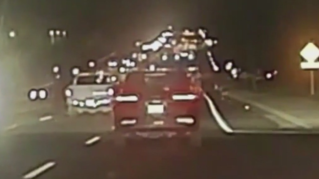 Hanging out of stolen car, shooting at officers