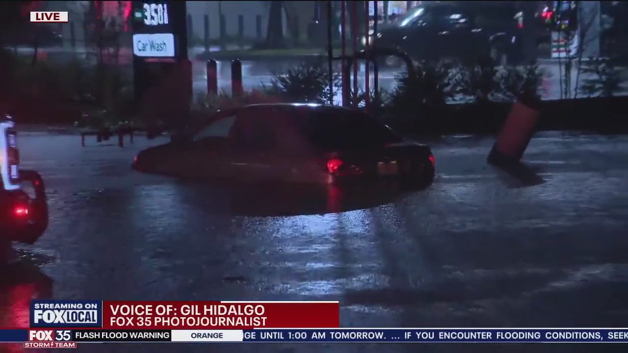 Car stuck in flooded roadway in Titusville