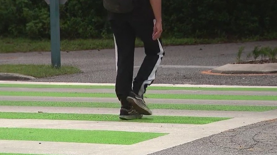 Green crosswalks in Seminole County being painted