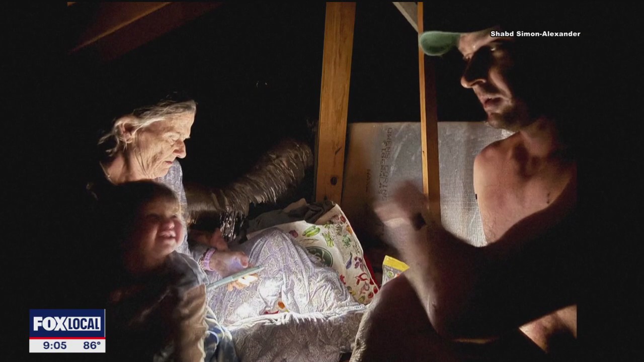 Family escapes to roof in Hunt flooding