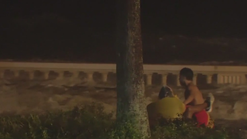 People ride the waves in tubes down Bayshore Boulevard