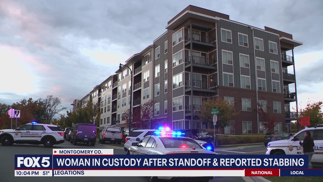 Woman in custody after standoff, reported stabbing