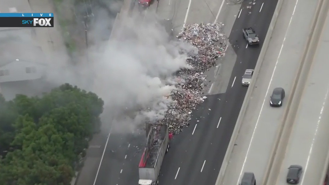 Garbage truck crashes, catches fire on 5 Freeway